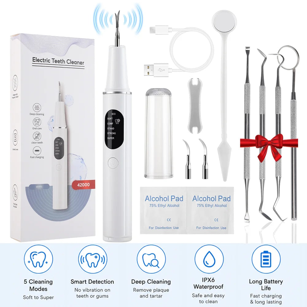 An electric teeth cleaner kit showing the main device, cleaning tools, and alcohol pads for dental use.
