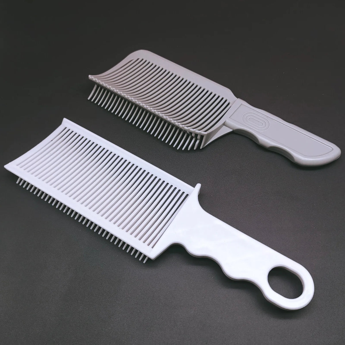 A set of professional flat top hair cutting combs in light gray and white.
