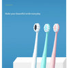 Un set de tres cepillos de dientes de alta densidad en blanco, azul claro y rosa, mostrados contra un fondo azul.
