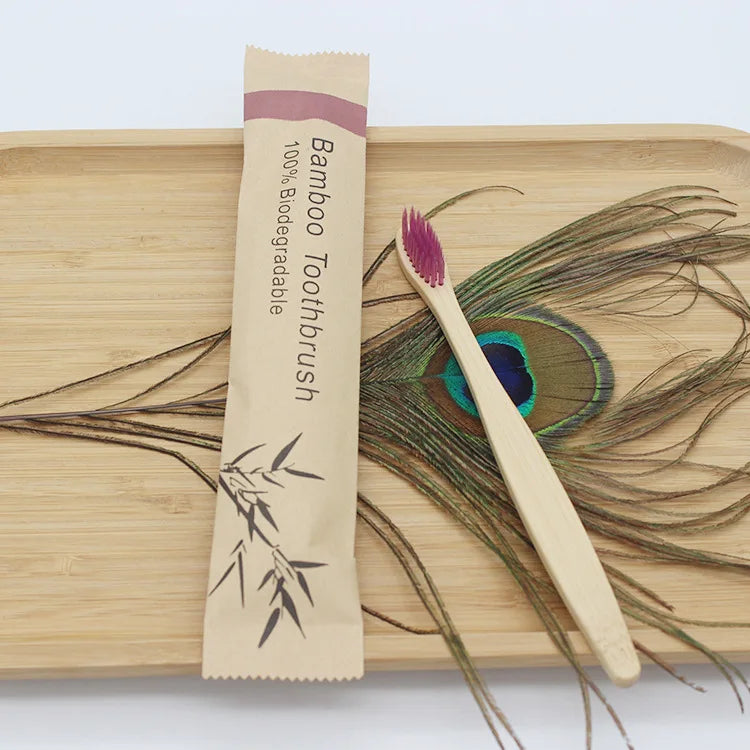 A bamboo toothbrush packaged in paper is shown next to a wooden cutting board and dried plant material.