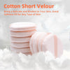 A stack of pink cotton short velour makeup puffs resting on white fluffy material.