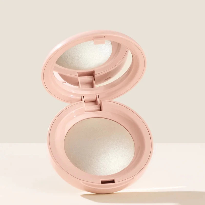 A pink liquid bronzer contour foundation stick with the cap open, showing a white product inside.
