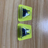 Two plastic containers holding precision electric shaver replacement blades on a wooden surface.