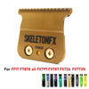A gold-colored skeleton FX70ZE barber trim knife set with a serrated blade and various attachments.