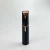 A sleek black electric facial hair remover with a gold accent, shown vertically.