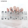 UV gel nail stickers featuring black and silver spiders and webs applied to fingernails.