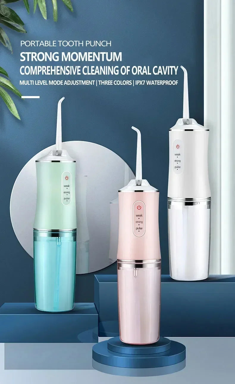 A portable tooth punch device in light green and pink colors is shown on a wooden surface.