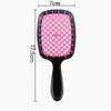 A pink anti-static air cushion hair comb and scalp massager with black handles.