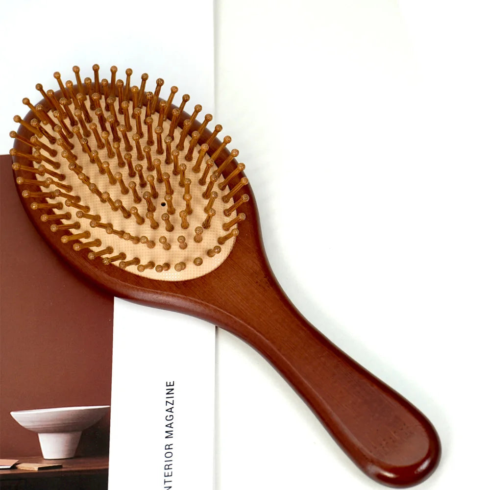 A wooden hair brush with numerous bristles is shown against a white background.
