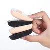 A hand holds a set of triangular cosmetic foundation puff brushes in light pink and black.