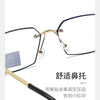 A pair of gold-rimmed eyeglasses with black frames and clear lenses, showing the details of the frame construction.