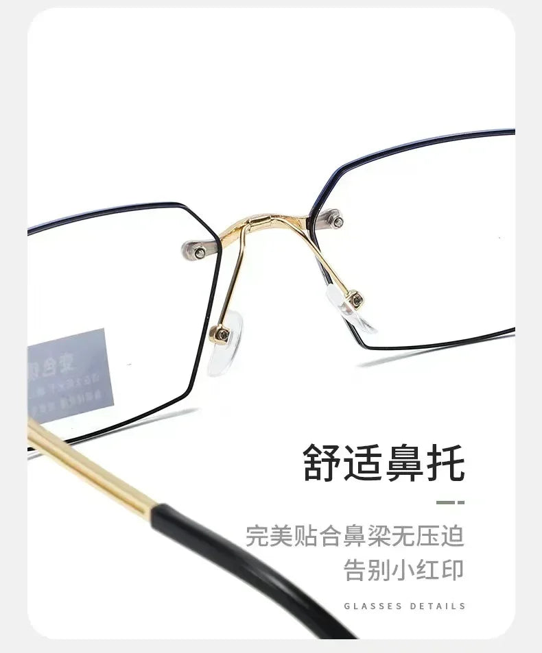 A pair of gold-rimmed eyeglasses with black frames and clear lenses, showing the details of the frame construction.