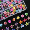A collection of colorful floral resin nail charms in various shades of pink, purple, yellow, and blue.