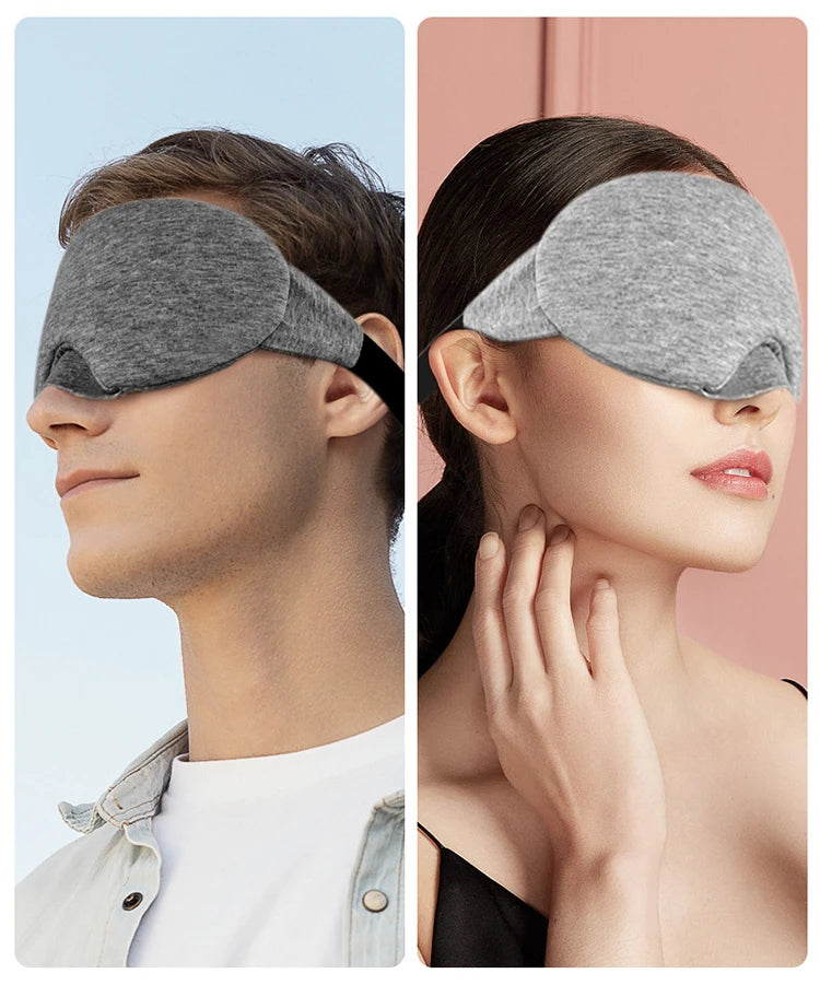 A man and a woman wearing gray 3D sleeping eye masks for sleep.