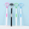 A collection of five silicone tongue scrapers in various colors including pink, black, green, and blue, displayed against a l