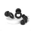 A collection of black silicone ear plugs, including various sizes and shapes, displayed on a white surface.