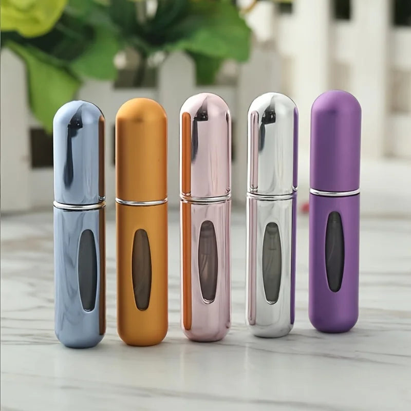 Five mini refillable perfume atomizer bottles in various colors including silver, orange, pink, and purple