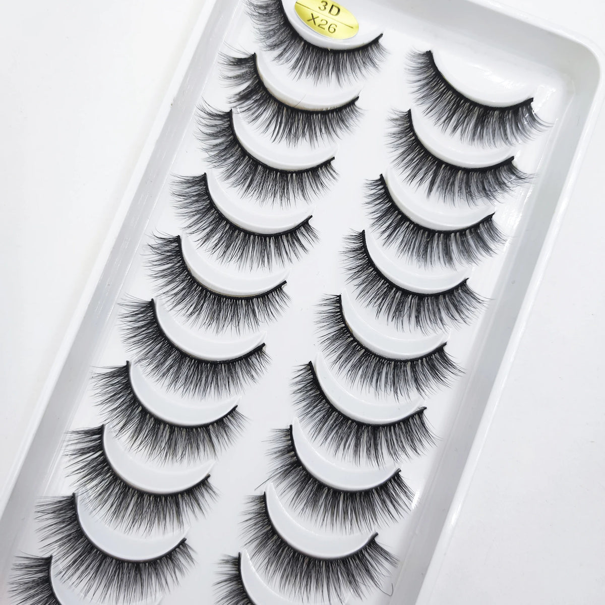 A tray of natural 3D mink false eyelashes displayed for sale.