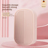 A pink storage box for a stainless steel nail clipper set is shown on a pink surface.