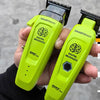 A hand holds a lime green SmartBrain digital brushless hairbrush device.