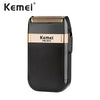Black Kemei KM-2024 electric shaver trimmer with an orange accent and textured head.