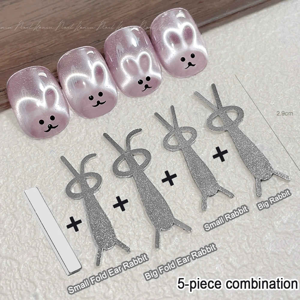 Un ensemble de 5 aimants à ongles lapin pailletés roses et petits charms oreilles en forme de lapin.