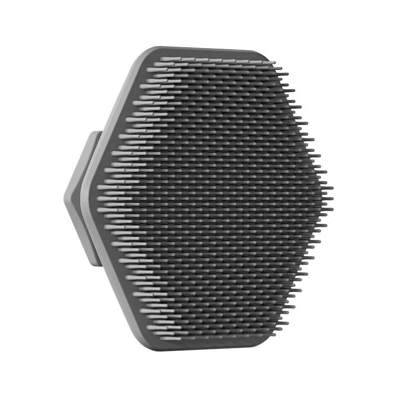 A black silicone facial cleaning brush with numerous fine bristles.