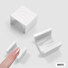 A white 5D cat eye magnet tool for nail art is shown with a hand holding one piece.