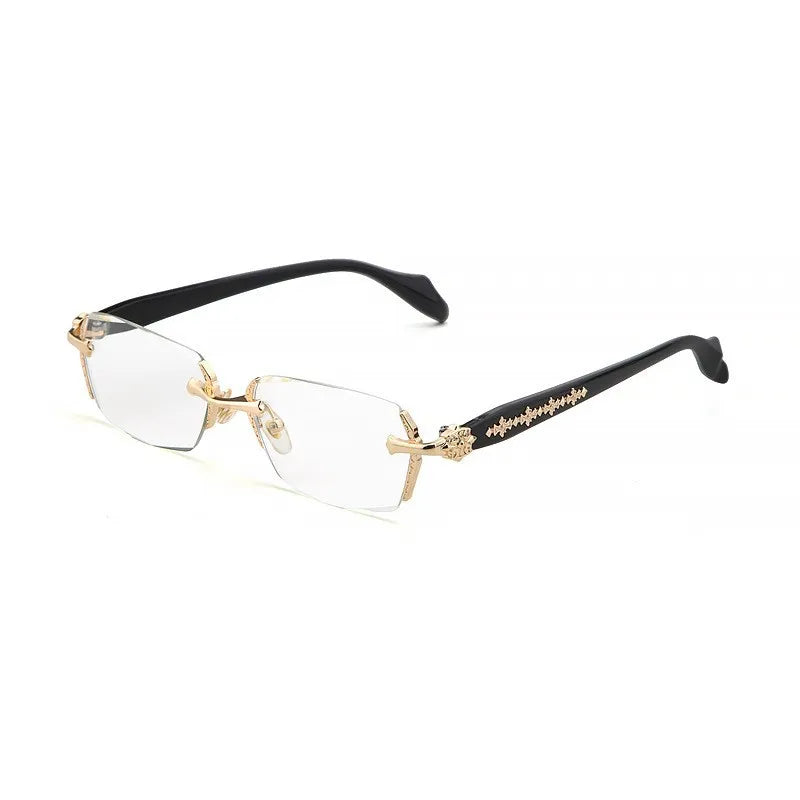 A pair of clear retro frameless reading glasses with black arms and gold detailing.