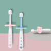 A set of pink and blue soft baby toothbrushes for toddlers displayed against a green and pink background.
