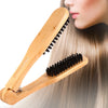 A professional double-sided wooden hair comb is shown being used on long, blonde hair.