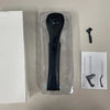 A black folding back shaver for men is displayed in its clear plastic packaging next to a box and a small brush.