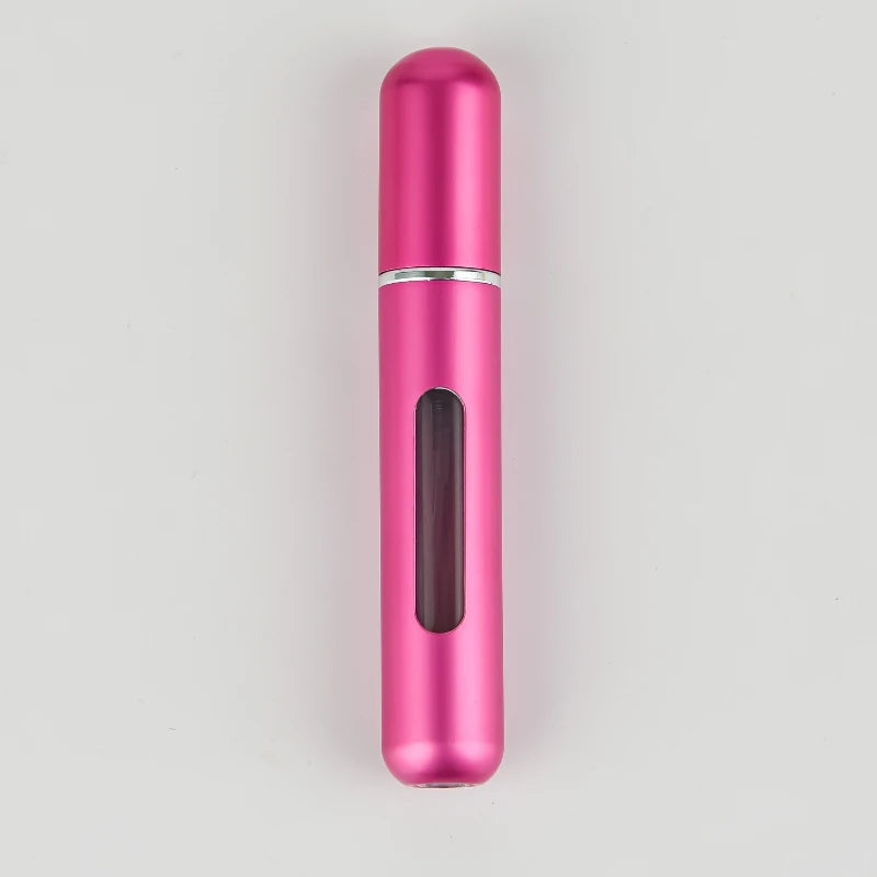 A sleek, cylindrical pink portable refillable perfume bottle with a silver band and a dark inner section.