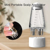 A clear mini portable scalp applicator with graduated markings and a white base, shown next to a hair comb.