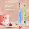A blue and green kids sonic electric toothbrush with cartoon designs is shown next to a pink mug and strawberries.