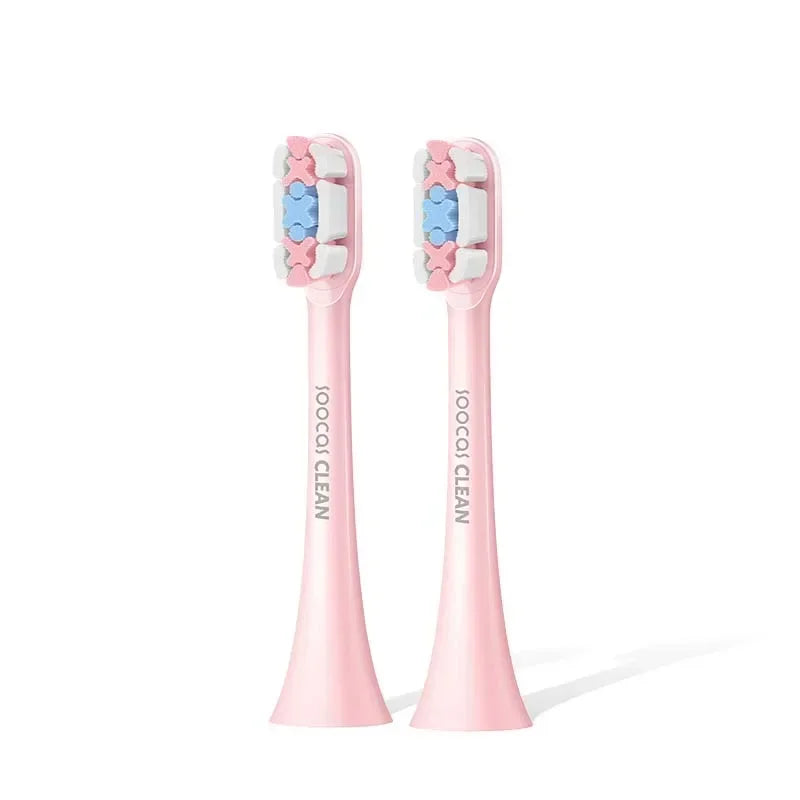 A pair of pink precision replacement brush heads for sonic toothbrushes with star-shaped bristles.