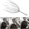 A stainless steel scalp massager is shown being used on a person's head for deep relaxation.