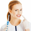 A woman in a white coat holds a blue brush head for oral care.