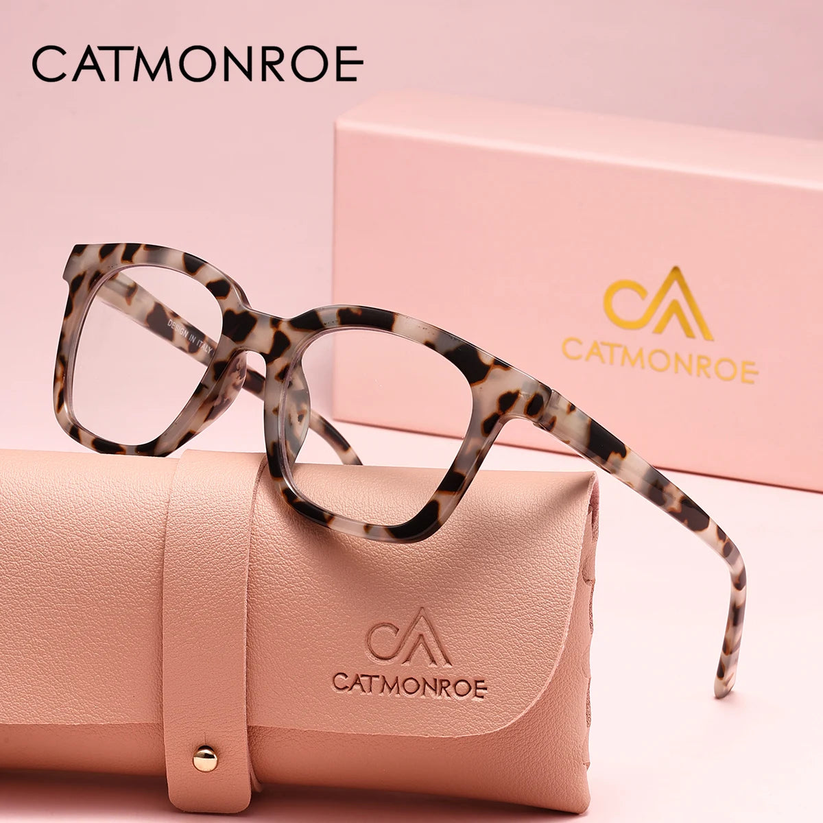 A pair of leopard print square reading glasses resting on a pink leather case.