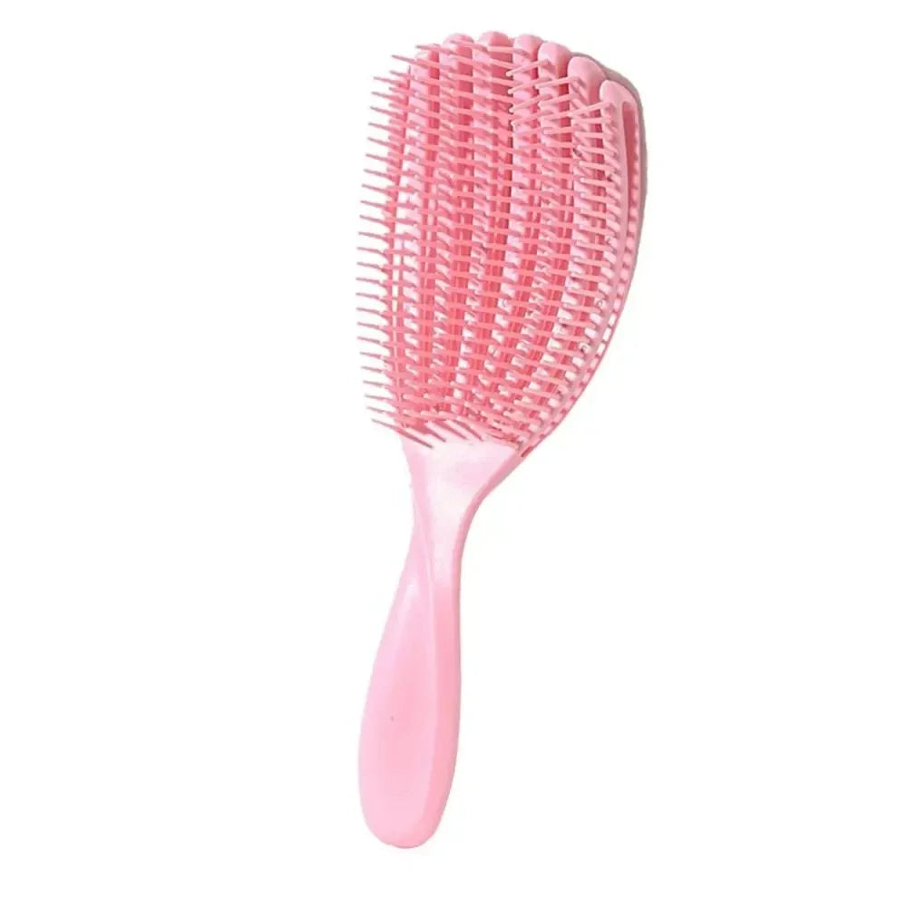 A pink massage detangler hair brush with fine bristles for styling curly and thick hair.