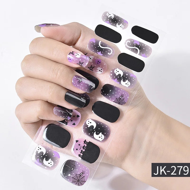 A hand displays various purple and black Halloween themed UV gel nail stickers for full coverage decals.