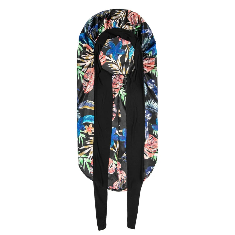 Extra large satin silk hair bonnet cap featuring a vibrant floral print in blue, pink, and green.