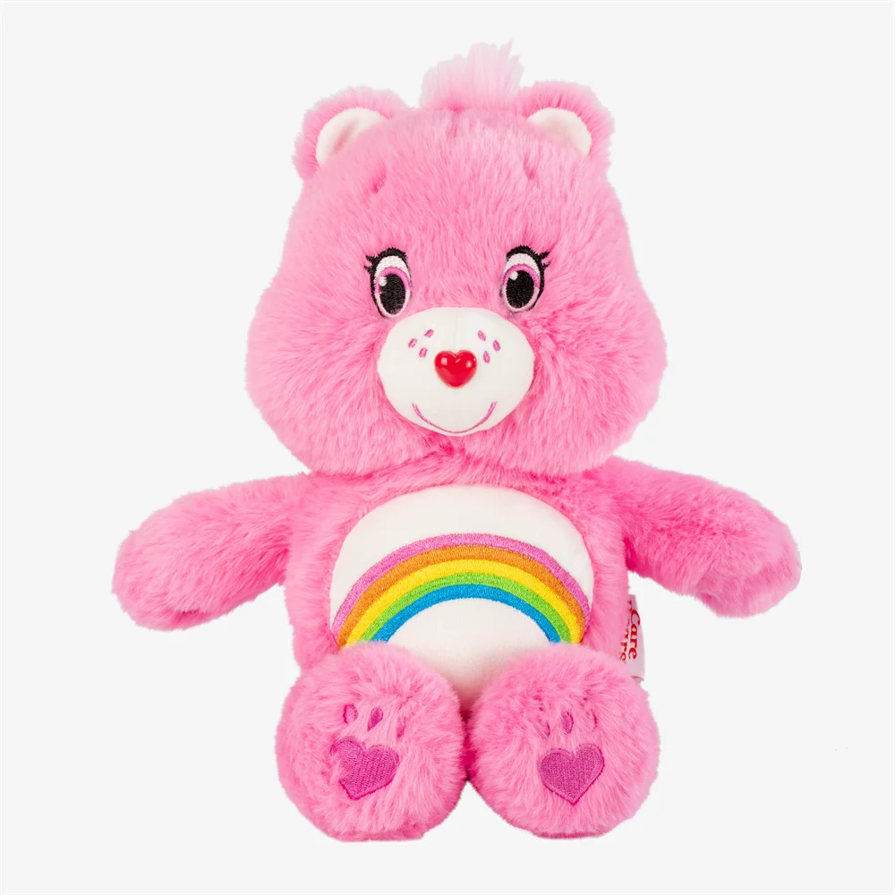 A pink classic care bears plush stuffed animal doll with a rainbow design on its chest