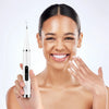 A woman is holding an electric dental calculus scaler device for oral cleaning.