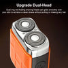Close-up of an orange and silver dual-head electric beard trimmer with a power button visible.