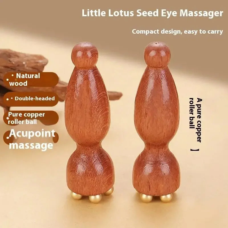 A pair of small wooden lotus seed eye massagers used for facial massage.