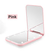 A pink portable LED magnifying makeup mirror shown in a closed and open view.