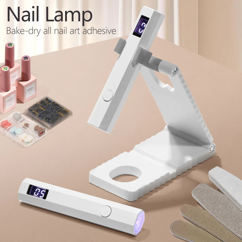 A white portable UV nail lamp device is shown with an adjustable arm and a separate light unit, next to nail art adhesive and