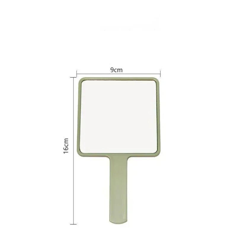 Miroir de maquillage rectangulaire vert clair à main avec poignée.