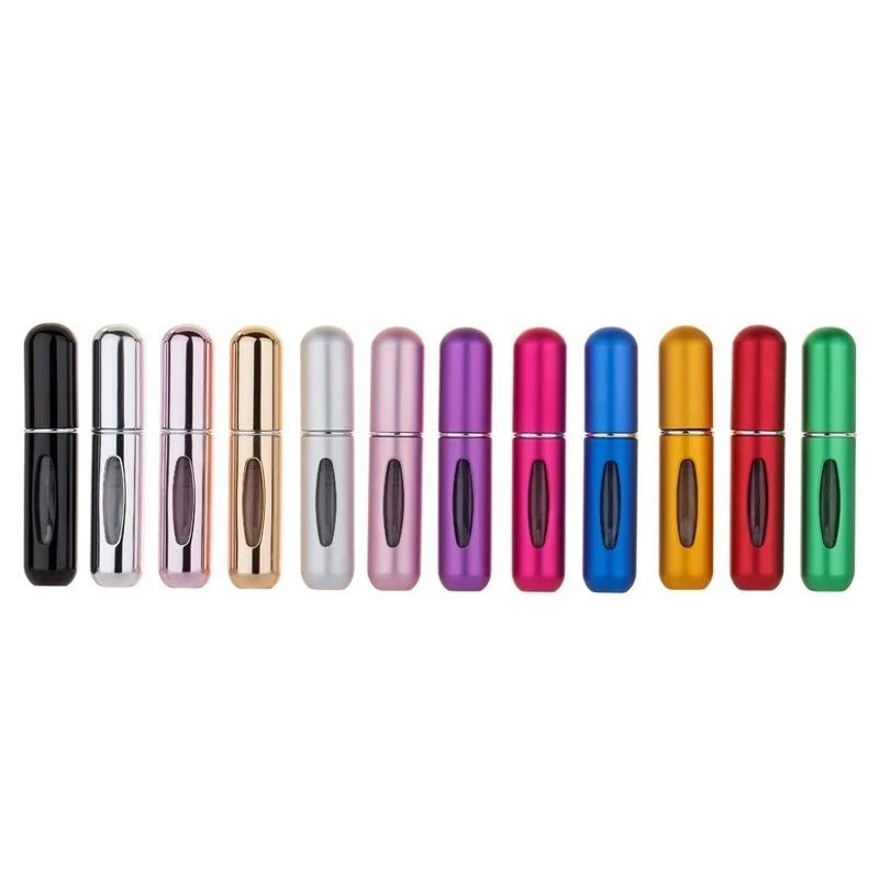 A row of portable refillable perfume bottles in various colors including black, pink, gold, and green.